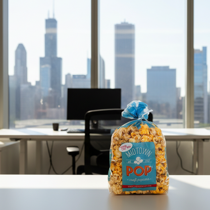 Bag of popcorn on a desk with a chicago skyline view